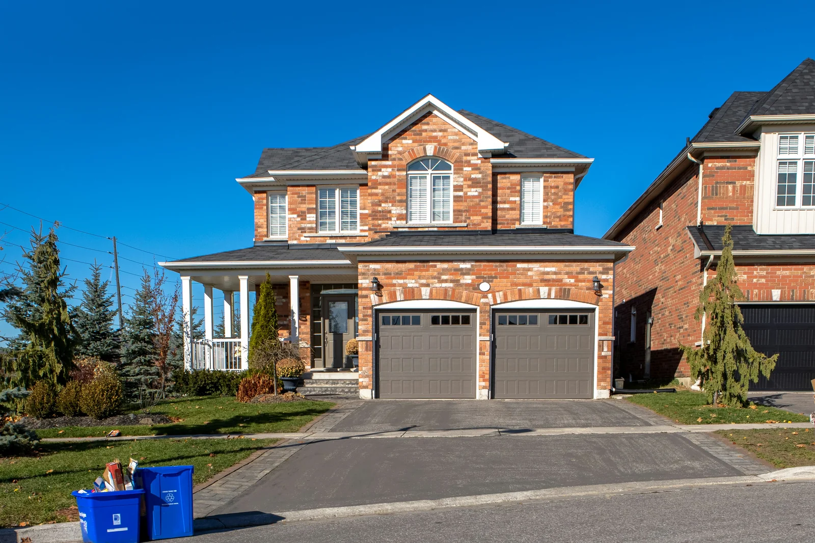 Newly paved black asphalt driveway leading to home