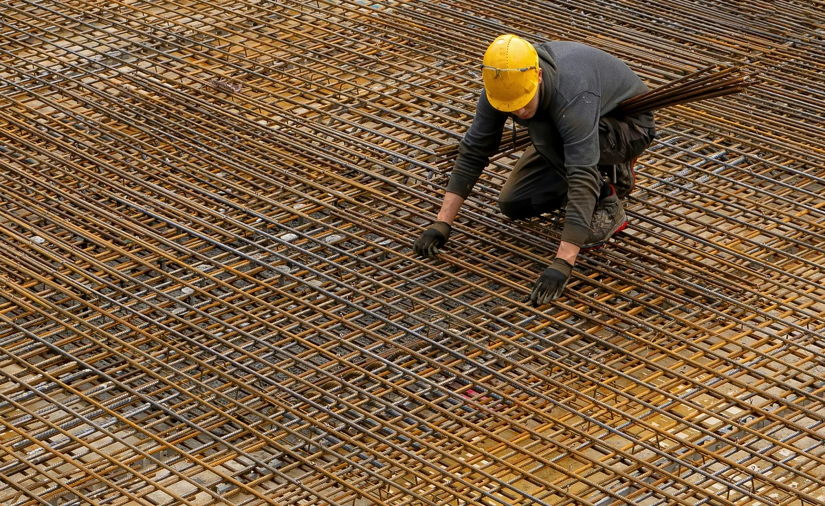 Foundation repair worker assessing slab