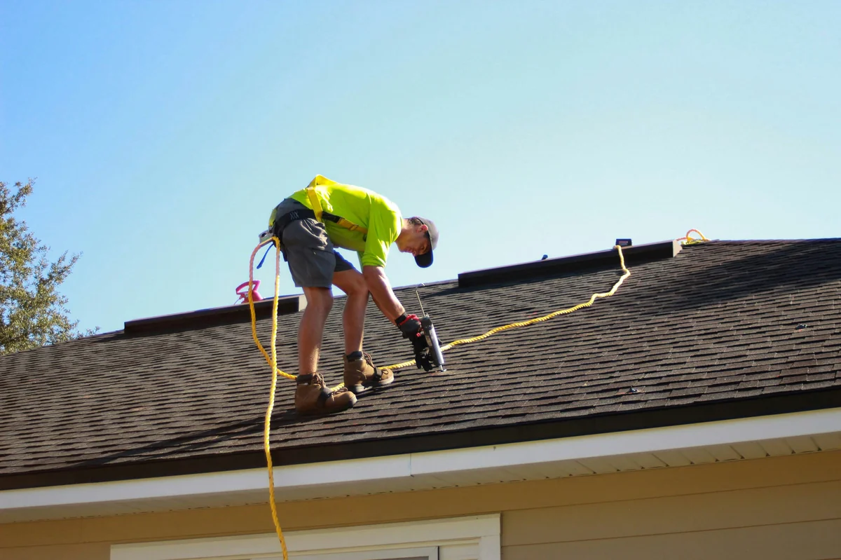 Roofing contractor working on roof installation