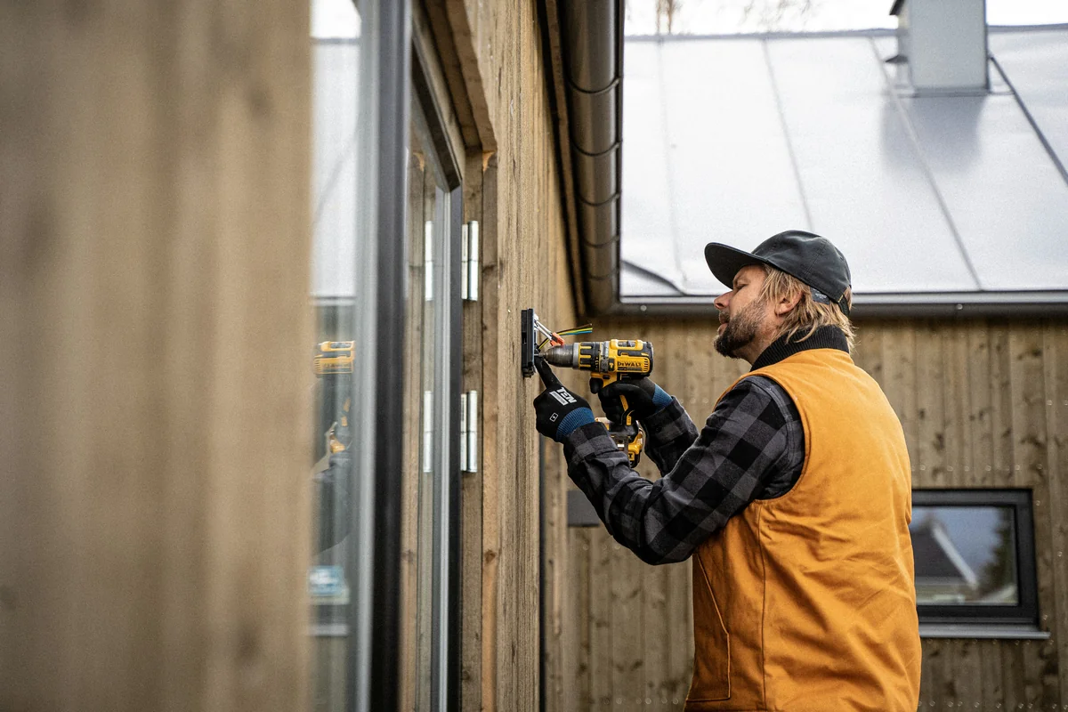 Window installer fitting new window in opening